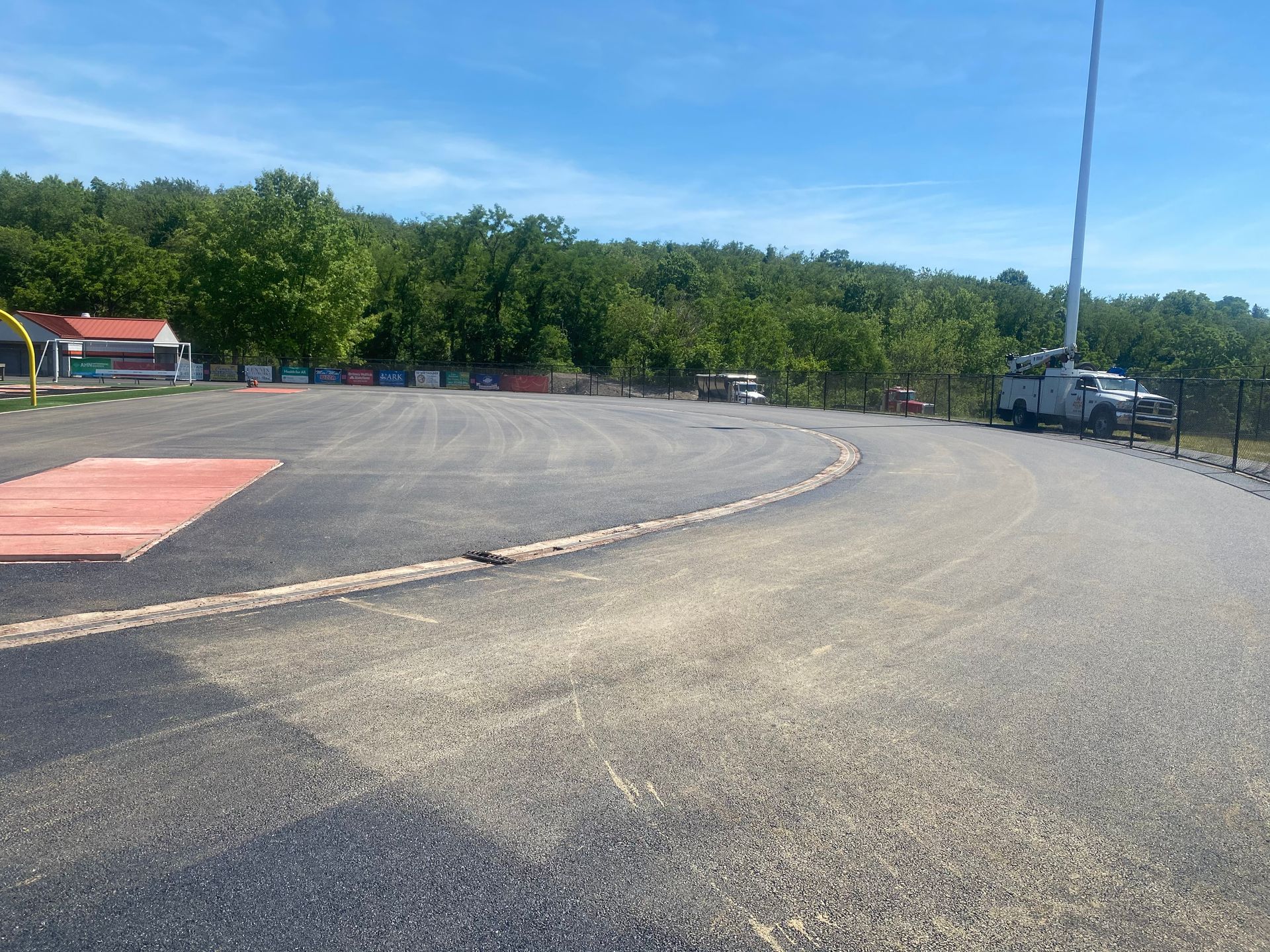 A truck is parked on the side of a curvy road.