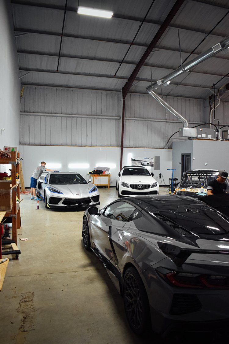 A group of cars are parked in a garage.