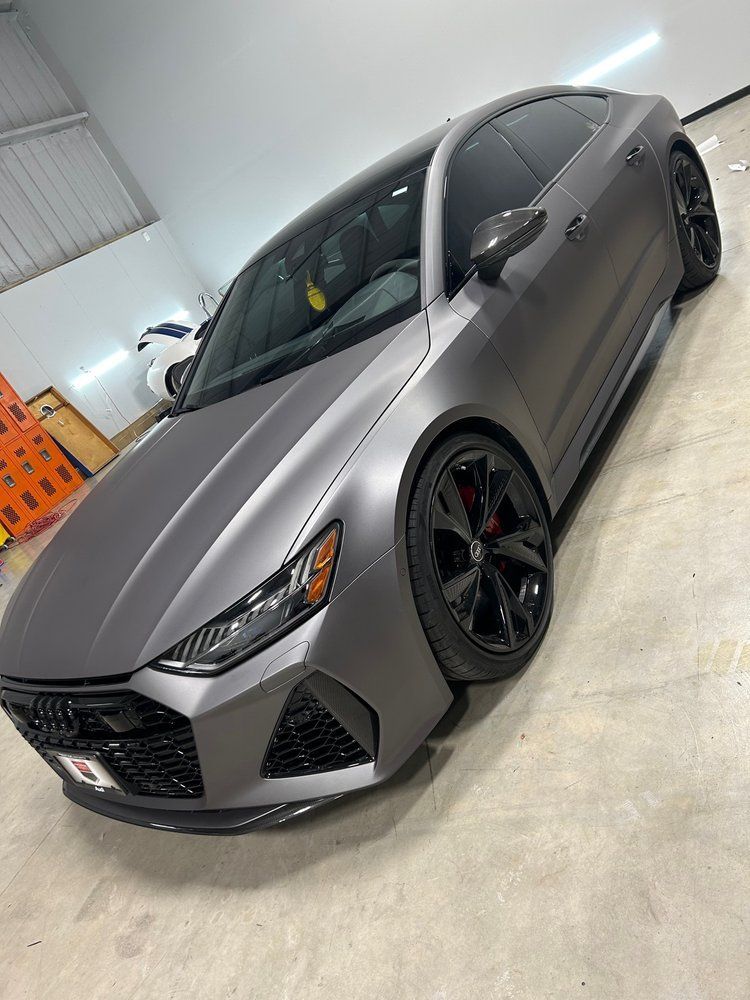A gray audi rs7 is parked in a garage.