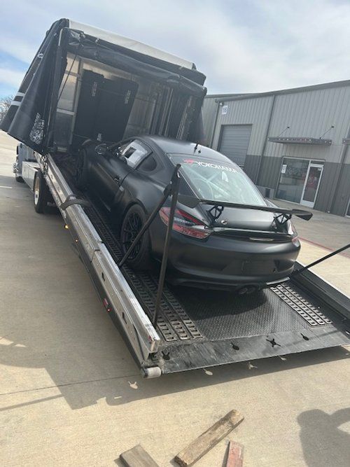 A car is sitting on top of a tow truck.