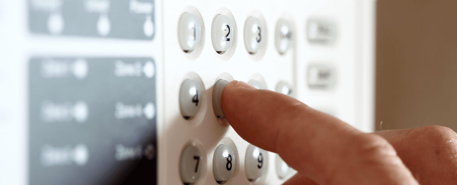 a person is pressing a button on a security system