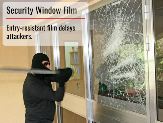 masked burglar attempting to get into the house and broken spider-webbed window with window kept together by security film
