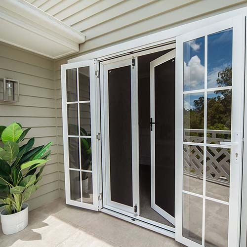 a white sliding glass door is open to a balcony .