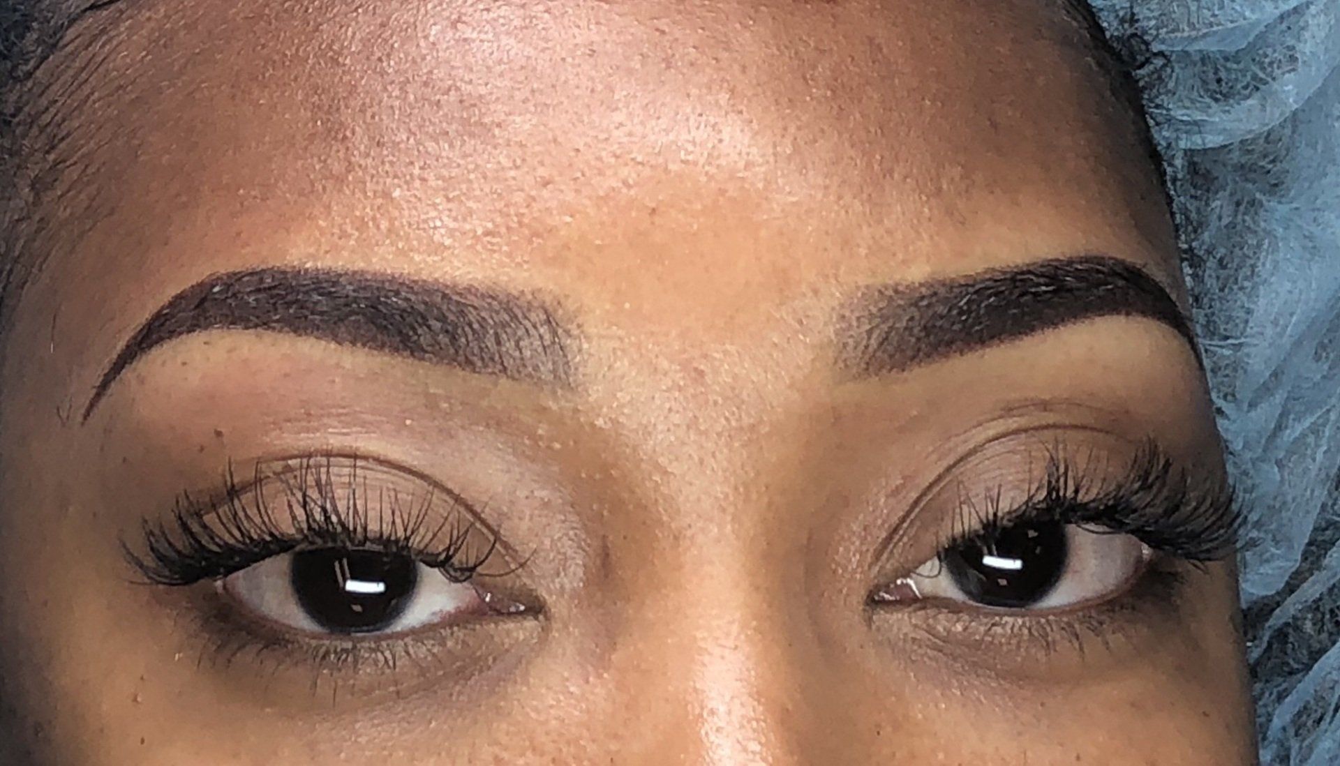 A close up of a woman 's eyebrows and eyelashes.