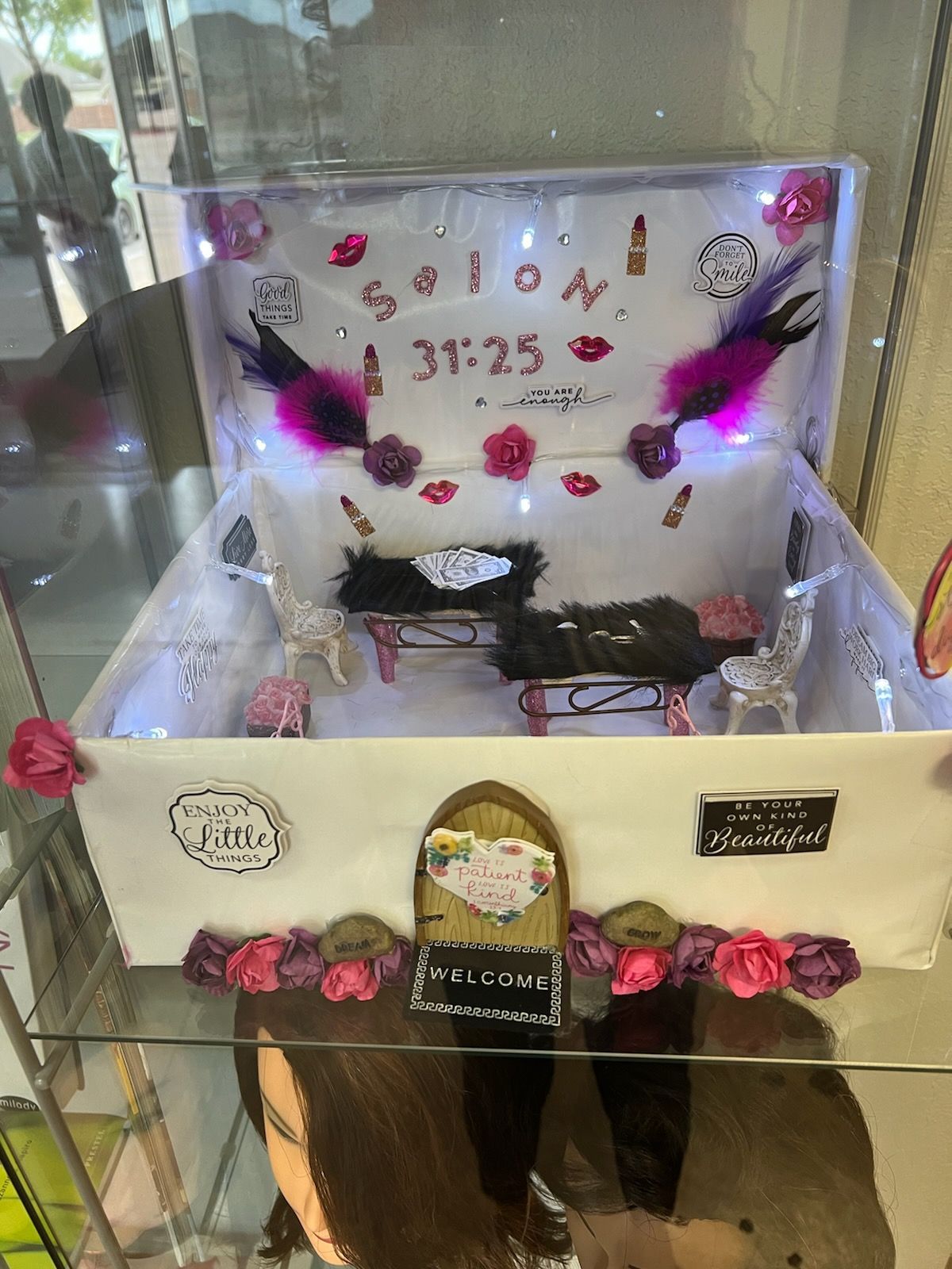 A white box with feathers and flowers on it