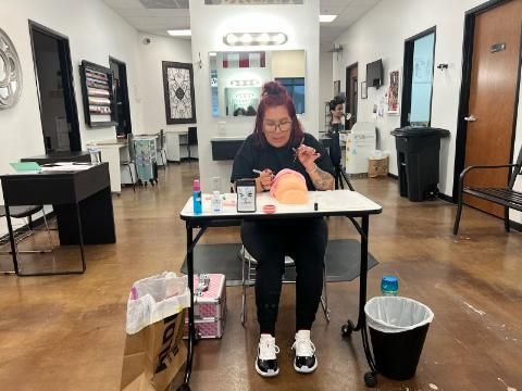 A woman is sitting at a table in a room.