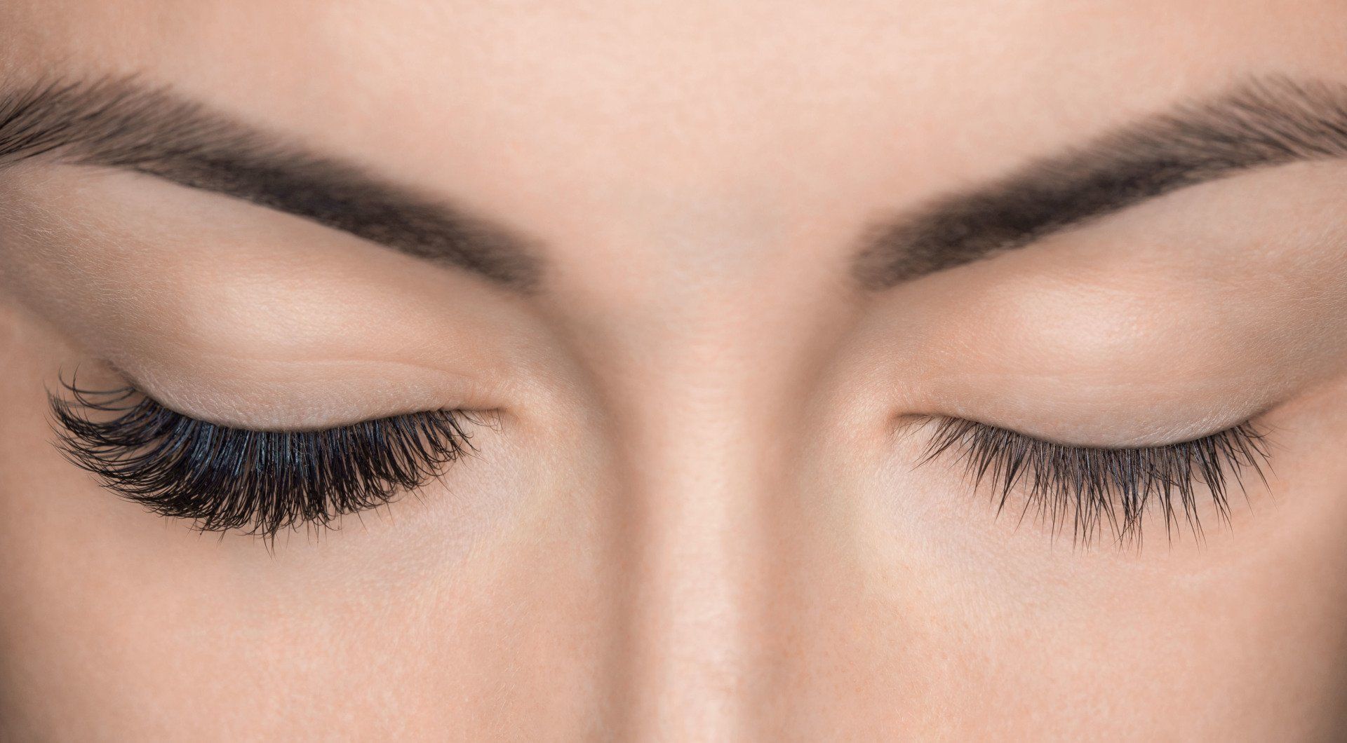 A close up of a woman 's eyes with long eyelashes.