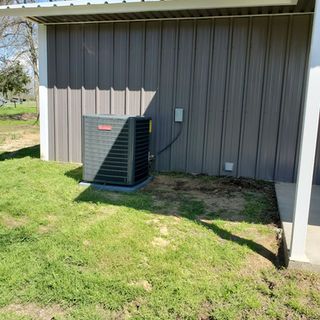 An air conditioner is sitting inside of a closet.