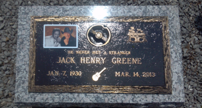 Bronze memorial plaque for Jack Henry Greene, featuring a small photo, a guitar icon, and dates: Jan. 7, 1930 - Mar. 14, 2013.