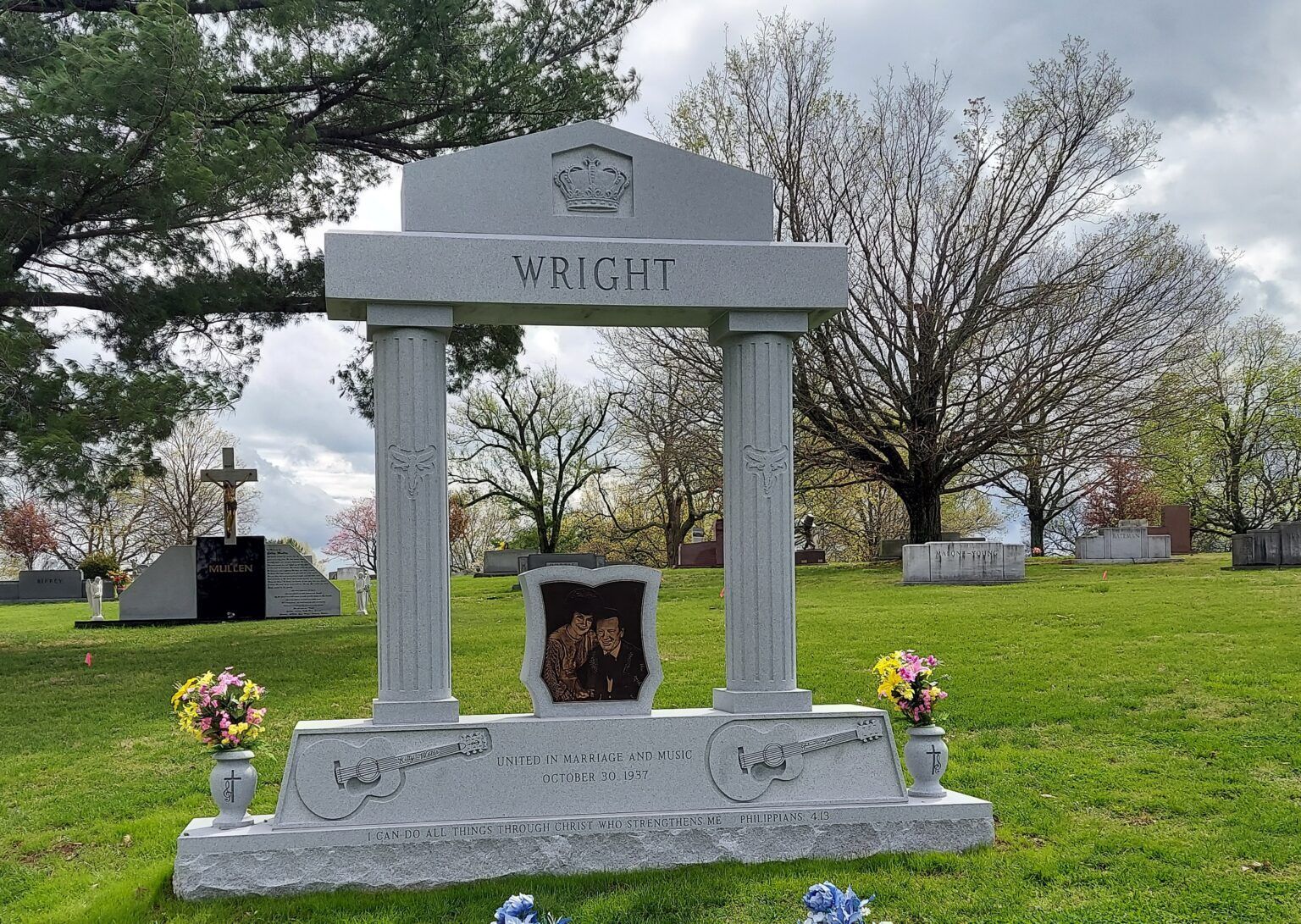 A gray granite tombstone with two columns and the name 