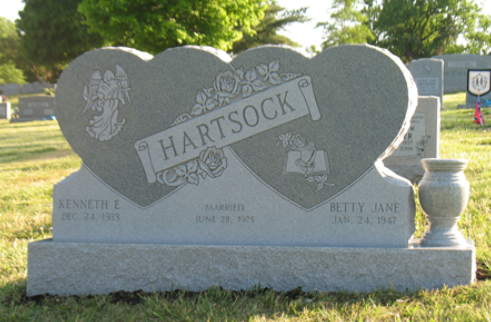 Double heart-shaped granite headstone with the name 