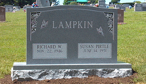 Gray granite headstone for the Lampkin family, with names Richard W. and Susan Pirtle and birth dates, in a cemetery.