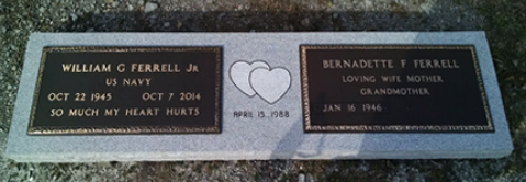 A grave marker for William G. Ferrell Jr. and Bernadette T. Ferrell with their names, dates, and a double-heart icon.