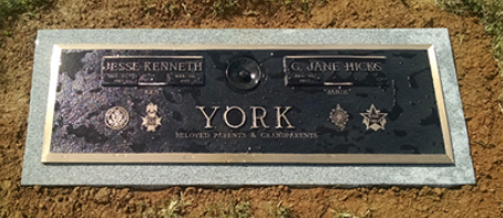 A bronze and granite double headstone for Jesse Kenneth and G. Jane Hicks York, marked 