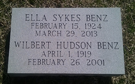 A gray granite headstone inscribed with the names and dates of Ella Sykes Benz (1924–2013) and Wilbert Hudson Benz (1919–2001).