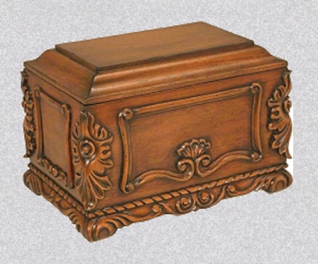 A rectangular wooden cremation urn with ornate, carved decorative borders and floral accents.