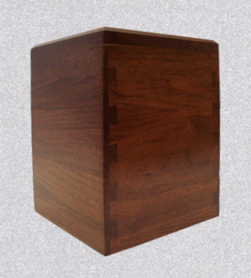 A dark-toned wooden box featuring prominent dovetail joints at the corner, displayed against a light gray background.