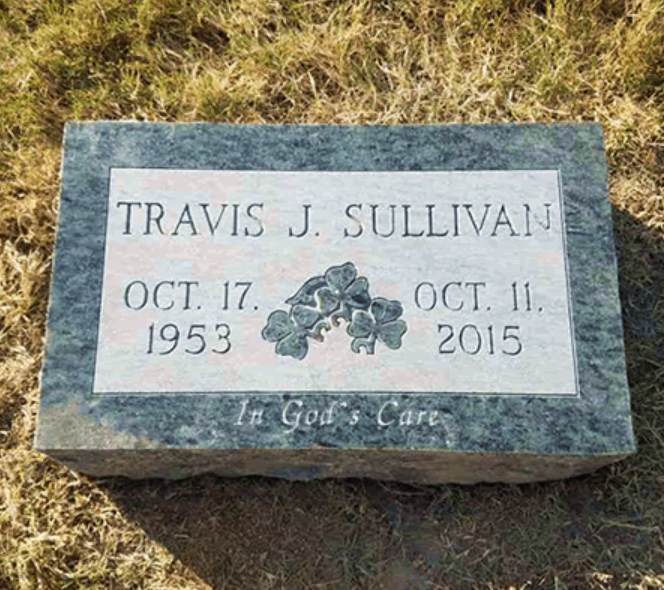 A headstone for Travis J. Sullivan, featuring a shamrock emblem, dates (1953–2015), and the inscription 