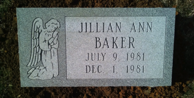 A grey granite headstone for Jillian Ann Baker (July 9, 1981 – Dec. 1, 1981) featuring an engraving of a kneeling angel.