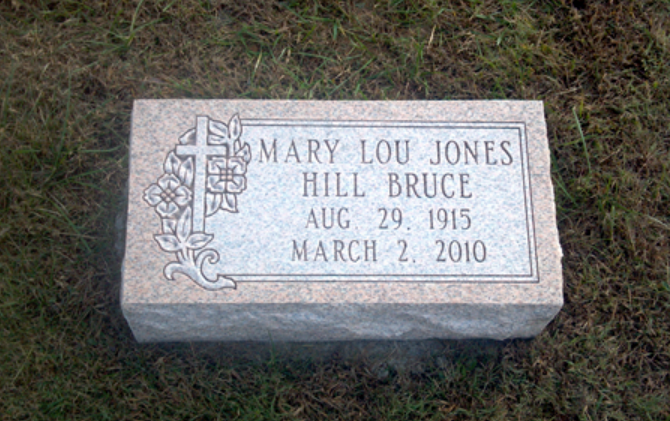 A rectangular stone grave marker for Mary Lou Jones Hill Bruce, dated Aug 29, 1915 to March 2, 2010, set in grass.