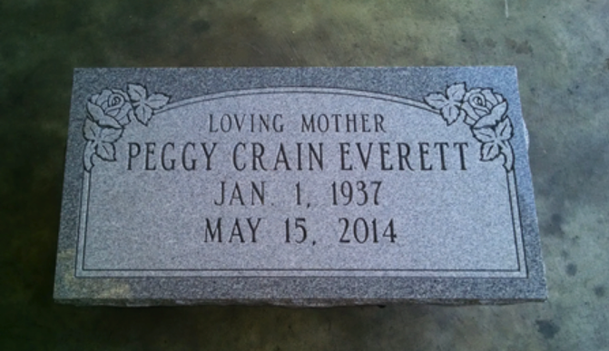 A gray granite gravestone for Peggy Crain Everett, inscribed with 
