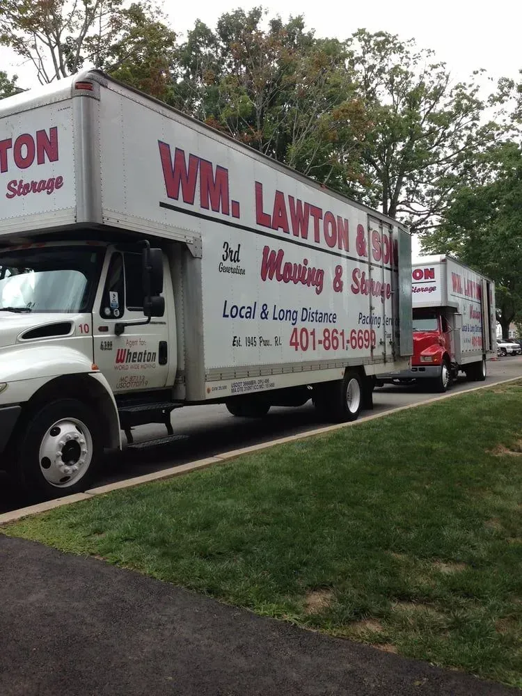 Two white moving trucks with 