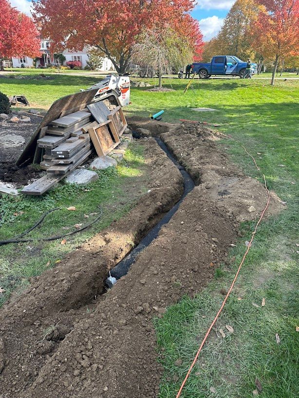 A drainage system is being installed in a yard.