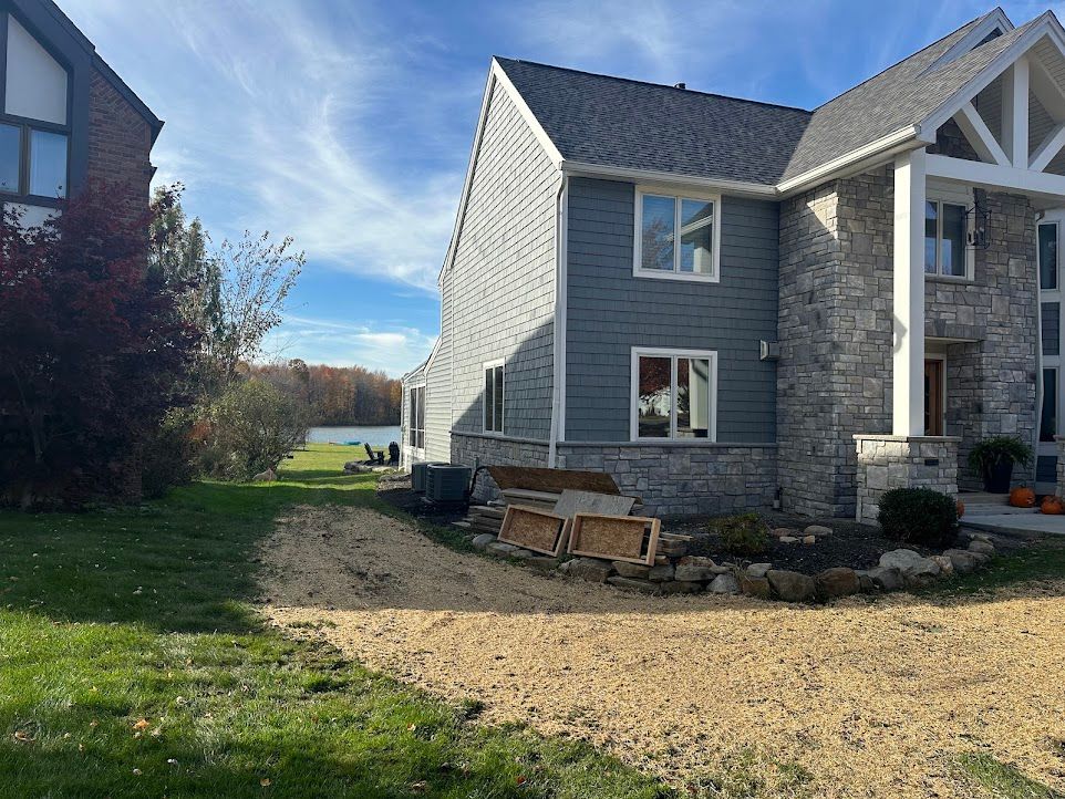 A large house with a lot of windows and a driveway leading to it.