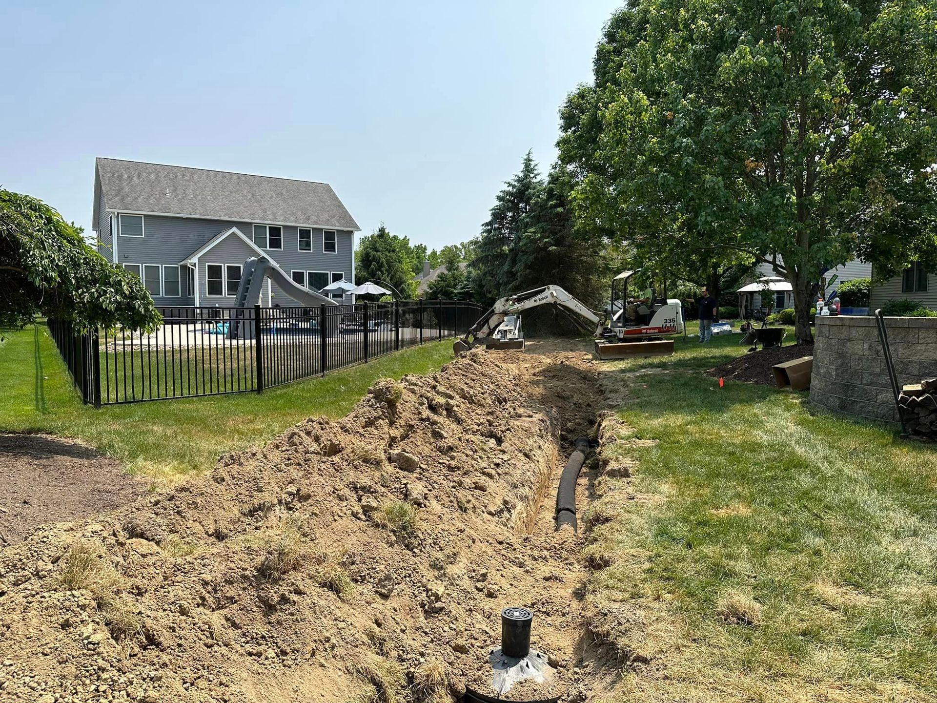 A large pile of dirt is sitting in front of a house.