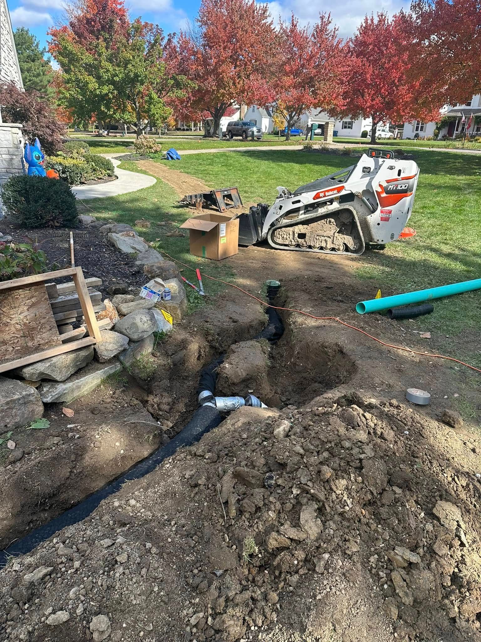 A bulldozer is digging a hole in the ground in a park.
