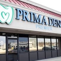 Exterior of a dental office with blue signage reading 