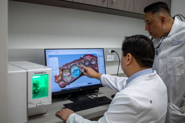 Two dentists viewing a screen in a dentists office