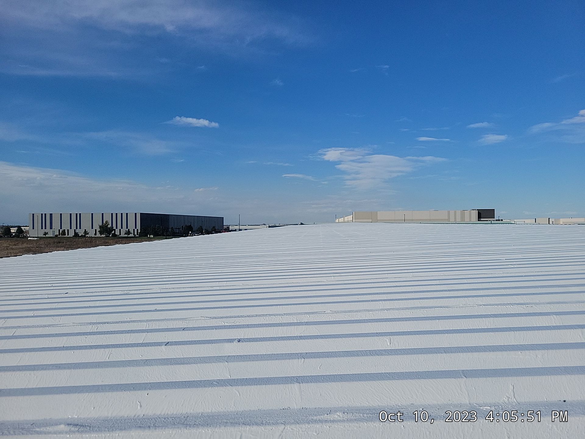 A snowy field with a blue sky in the background