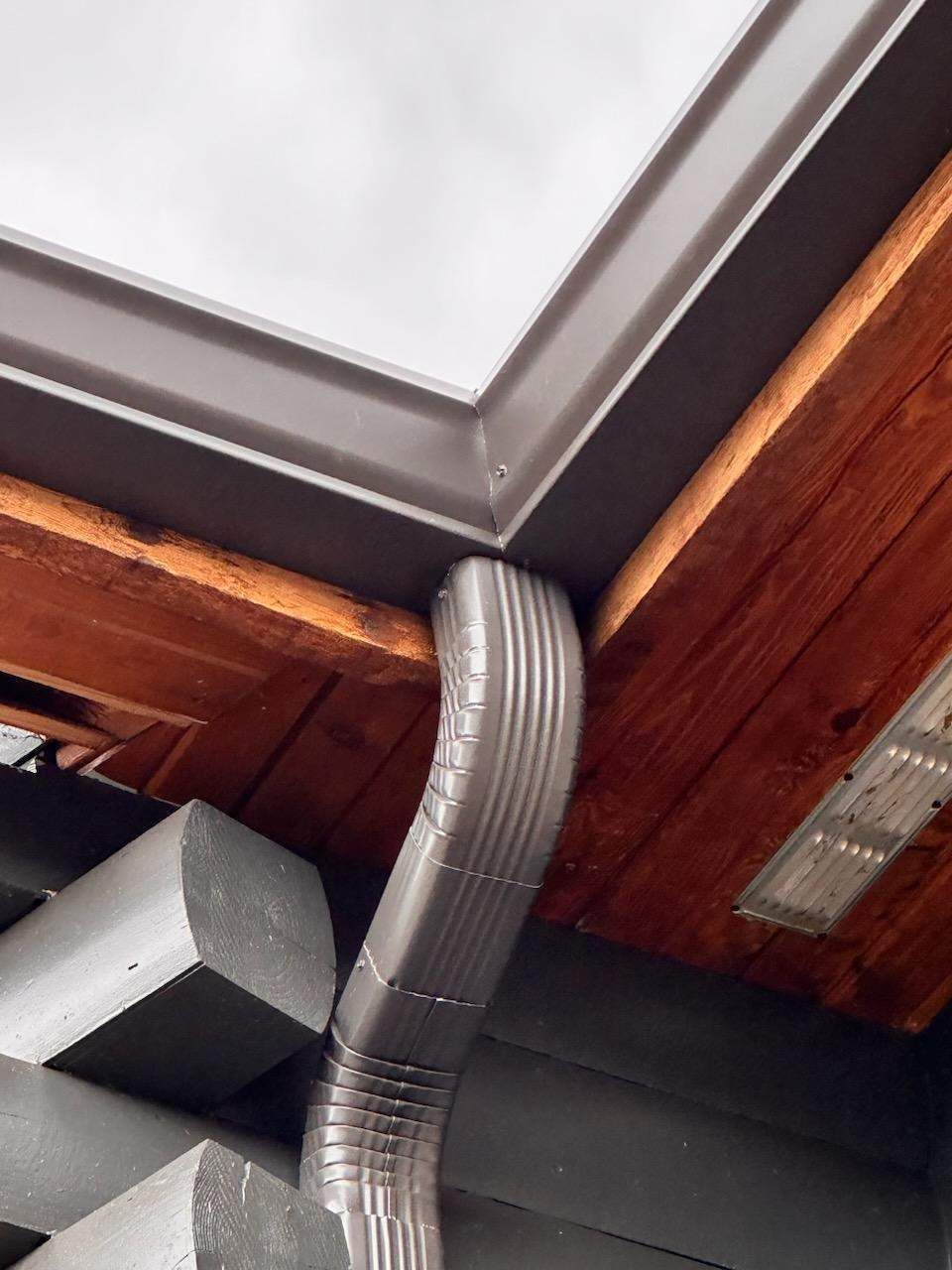 A gutter is hanging from the ceiling of a building