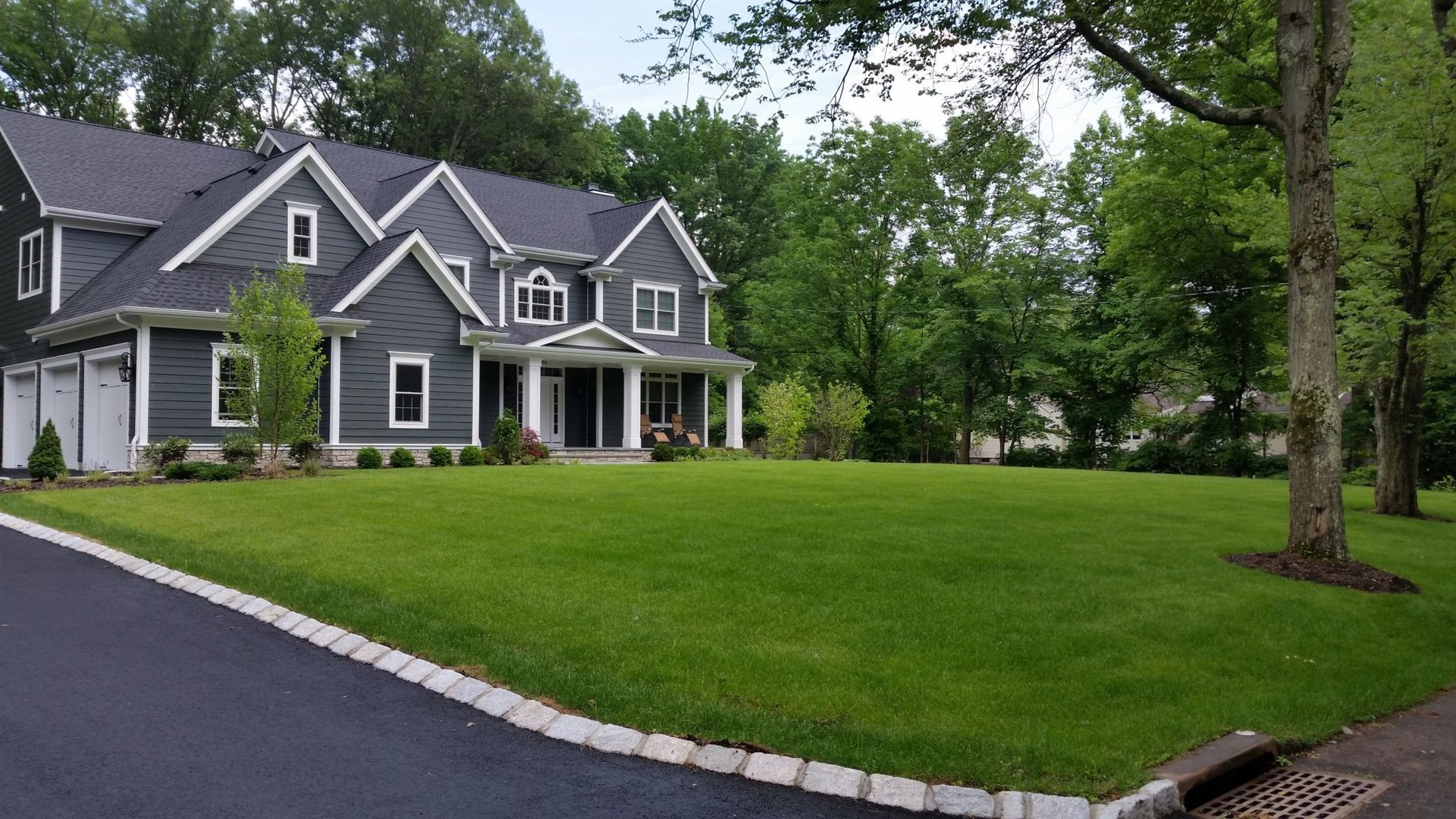 A large house with a lush green lawn in front of it