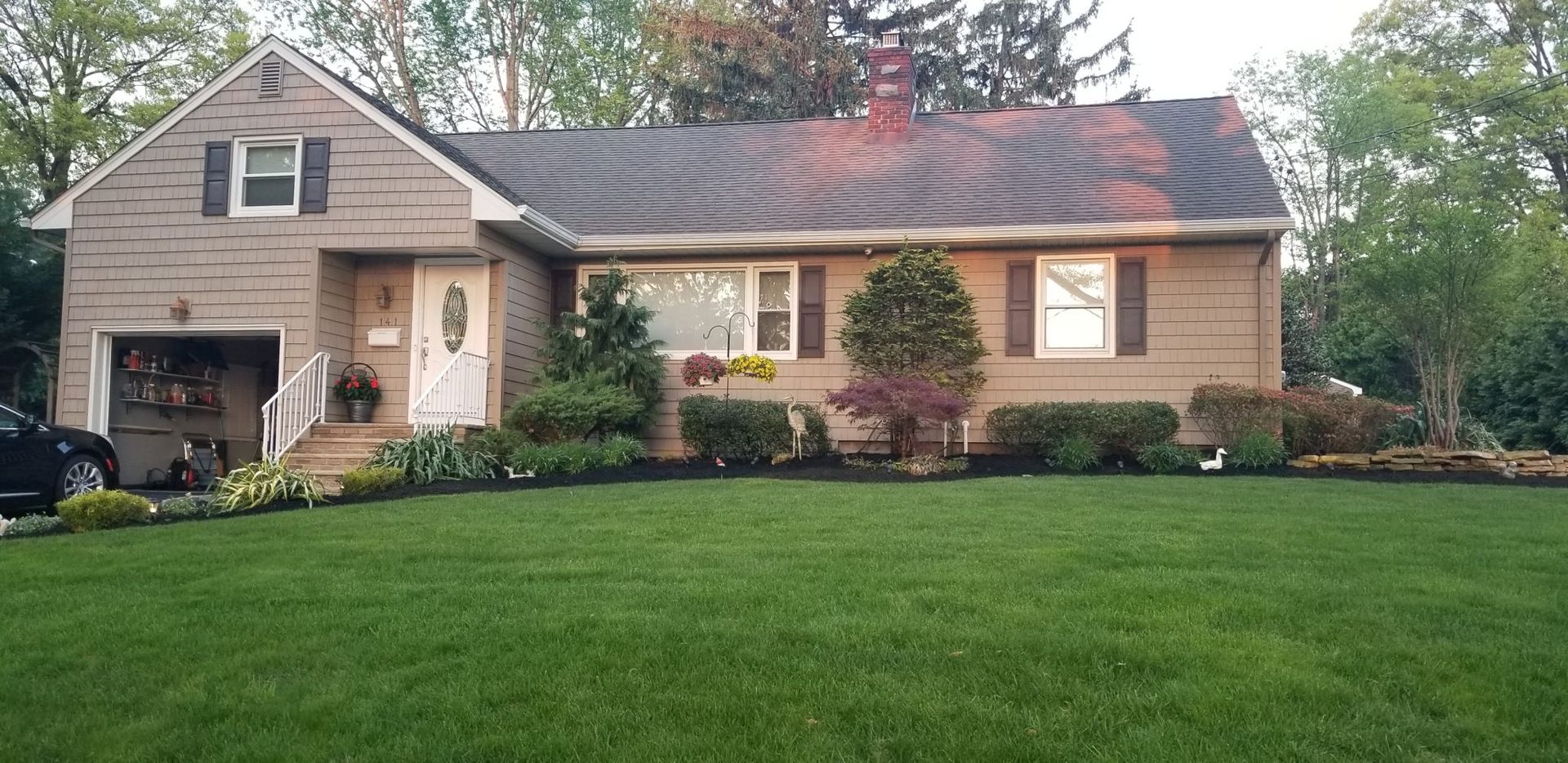 A house with a lush green lawn in front of it