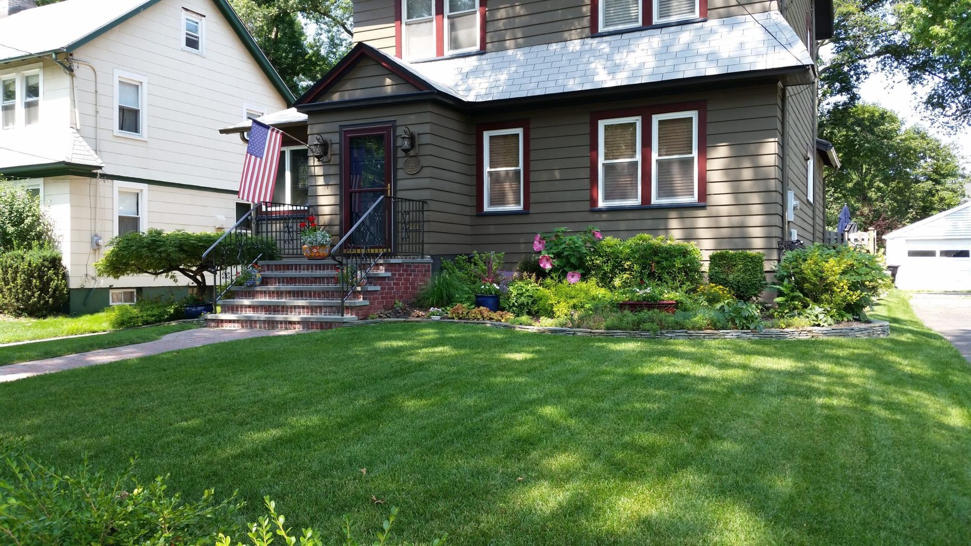 A house with a large lawn in front of it