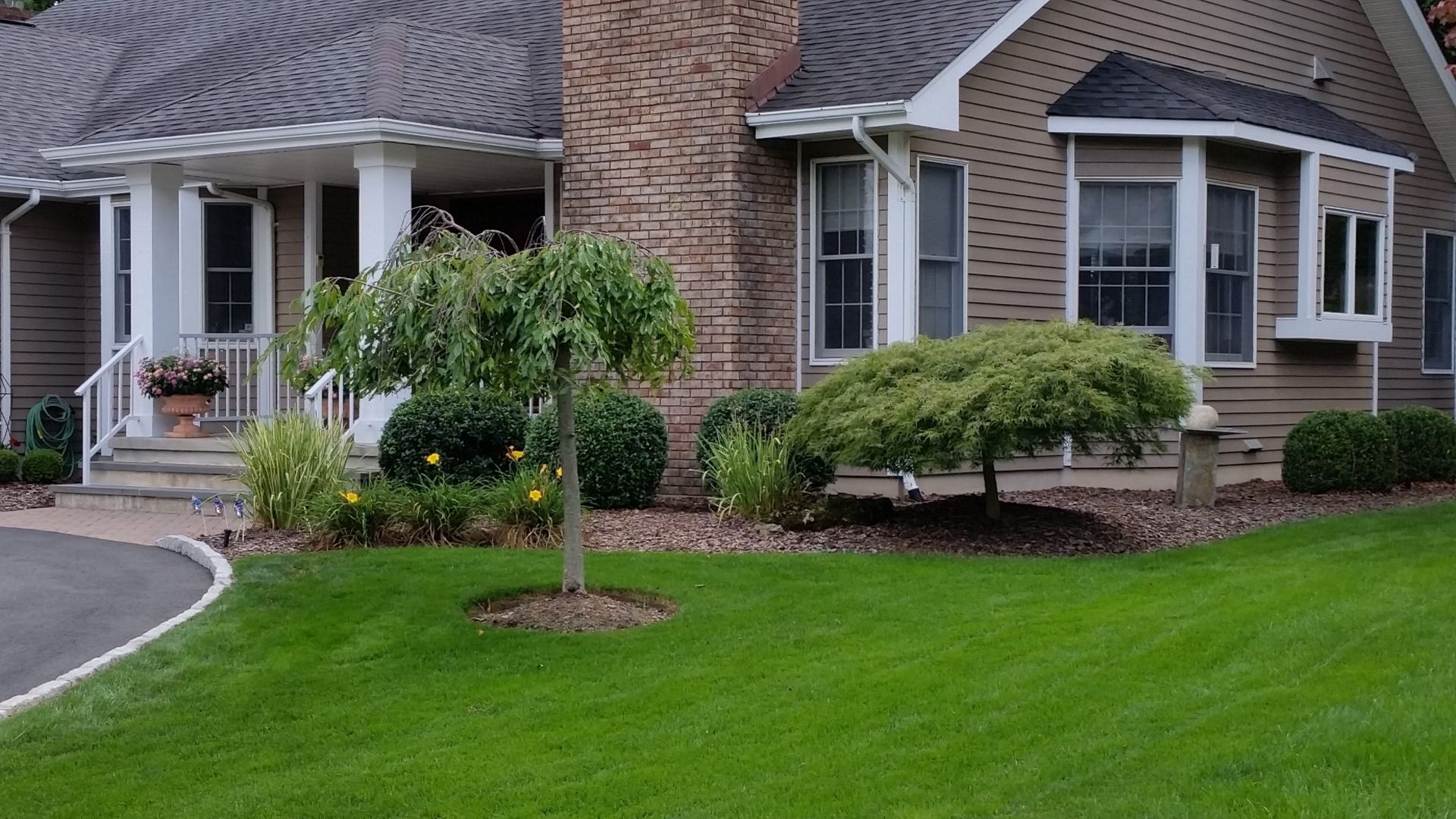 A large house with a lush green lawn in front of it