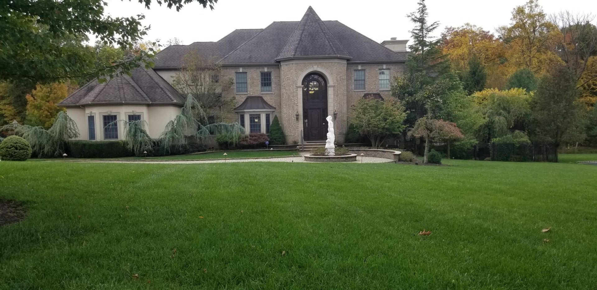 A large house with a lush green lawn in front of it