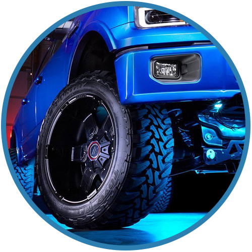 A blue truck with black wheels and tires