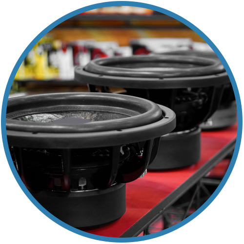 A row of speakers are lined up on a conveyor belt
