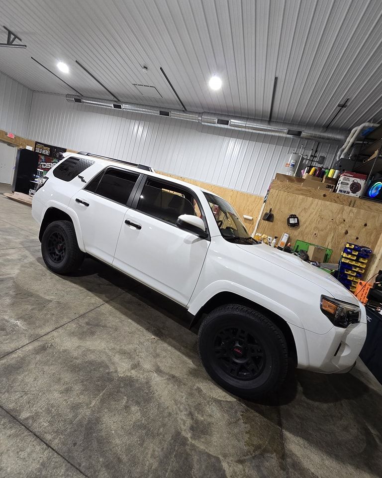 A white suv is parked in a garage.