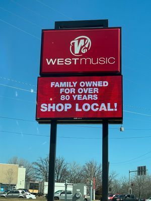Red sign for West Music. Sign says 