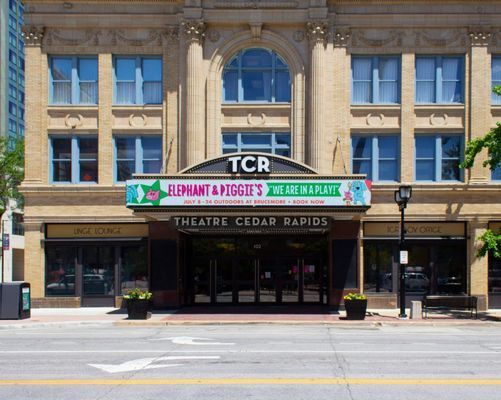 Theater Cedar Rapids exterior with a playbill that says 