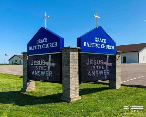 Two signs for Grace Baptist Church with text 