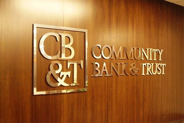 CB&T Community Bank & Trust sign on a wood-paneled wall.