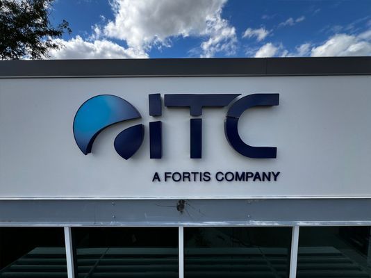 ITC logo above a company name, against a blue sky.