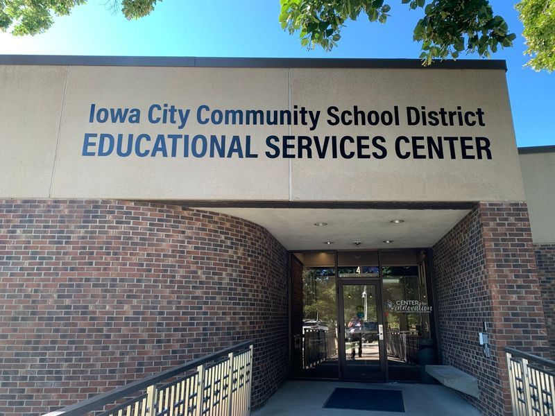 Iowa City Community School District Educational Services Center entrance with brick facade and sign.