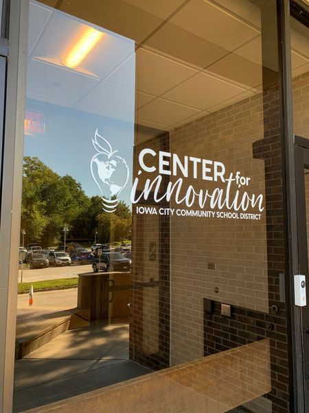 Glass door with a white logo for the 