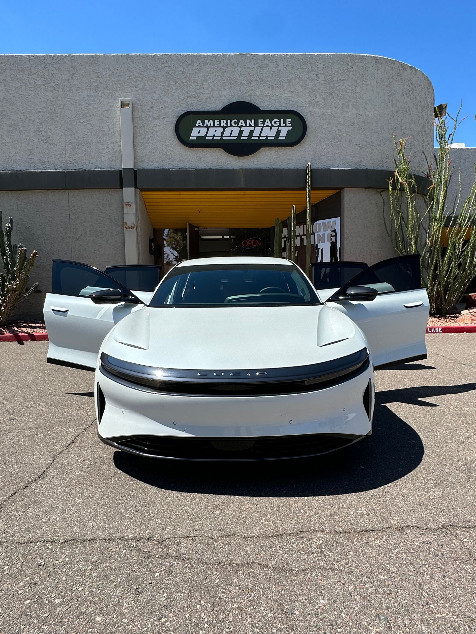 White four door car with doors open